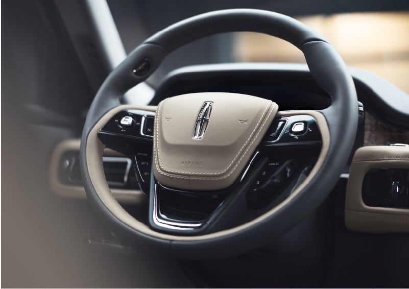 The intuitively placed controls of the steering wheel on a 2023 Lincoln Aviator® SUV | Miller Lincoln in Saint Cloud MN