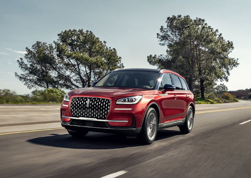 A 2023 Lincoln Corsair® SUV is shown being driven on a country road. | Miller Lincoln in Saint Cloud MN