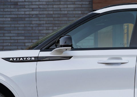 The driver’s side door and fender badging of a white 2026 Lincoln Aviator® SUV are showcased. | Miller Lincoln in Saint Cloud MN