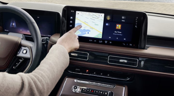 A person is tapping the center display touchscreen of a 2026 Lincoln Aviator® SUV. | Miller Lincoln in Saint Cloud MN