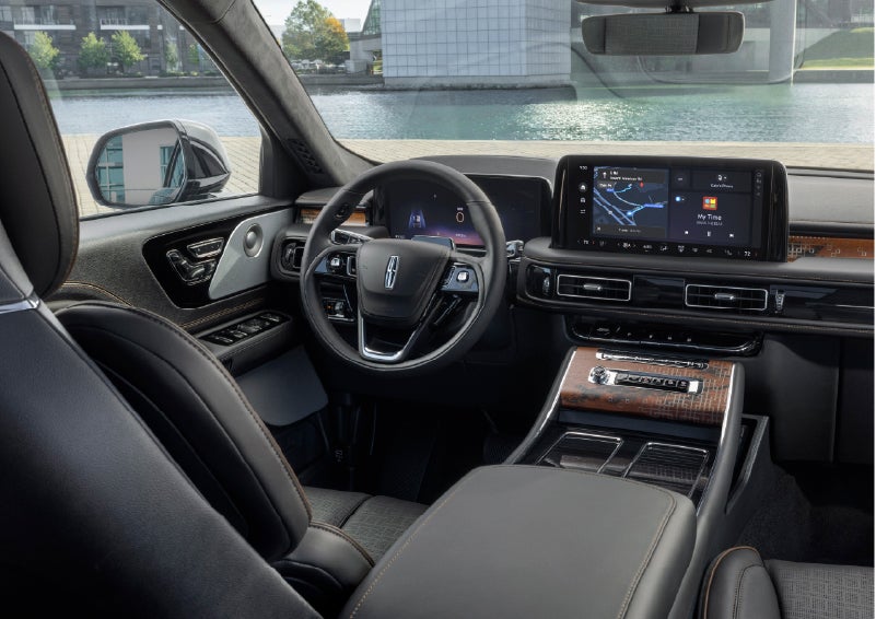 The interior of the 2026 Lincoln Aviator® SUV is shown parked with a view of a harbor through the windshield. | Miller Lincoln in Saint Cloud MN