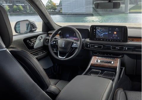 The interior of the 2026 Lincoln Aviator® SUV is shown parked with a view of a harbor through the windshield. | Miller Lincoln in Saint Cloud MN