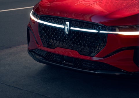 The available front LED light bar and center Lincoln Star logo glow at dusk. | Miller Lincoln in Saint Cloud MN