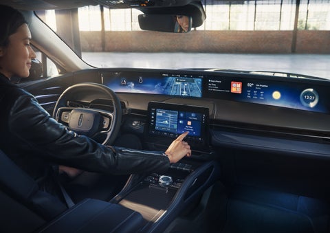 The driver of a 2026 Lincoln Nautilus® SUV interacts with the center touchscreen. | Miller Lincoln in Saint Cloud MN