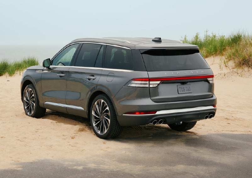 A 2027 Lincoln Aviator® SUV is parked next to sand dunes. | Miller Lincoln in Saint Cloud MN