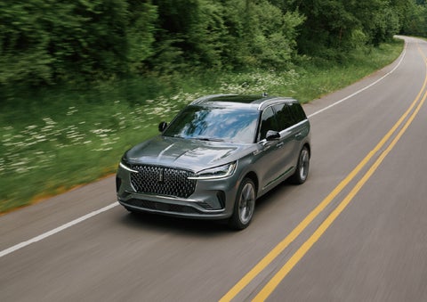 A 2027 Lincoln Aviator® SUV is being driven down a road. | Miller Lincoln in Saint Cloud MN