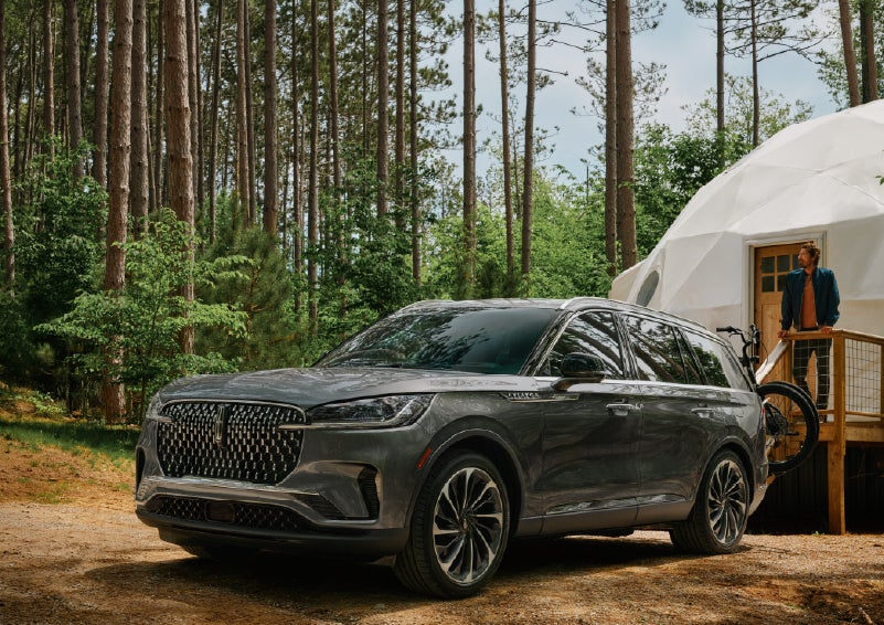 A 2027 Lincoln Aviator® is parked next to a high end glamping site. | Miller Lincoln in Saint Cloud MN