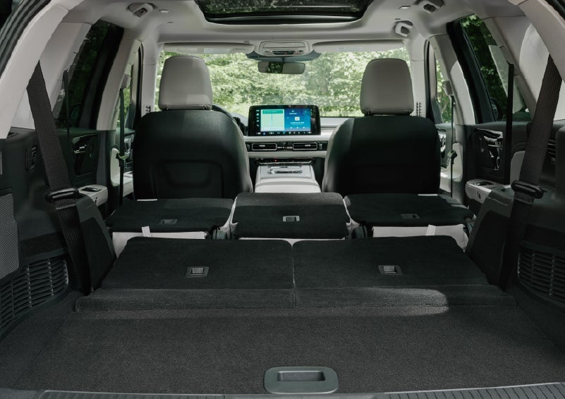 A rear to front view of the interior of a 2027 Lincoln Aviator® Black Label™ SUV shows the third and second rows folded flat | Miller Lincoln in Saint Cloud MN