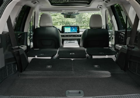 A rear to front view of the interior of a 2027 Lincoln Aviator® Black Label™ SUV shows the third and second rows folded flat | Miller Lincoln in Saint Cloud MN