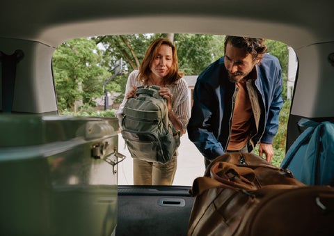 A couple loads luggage into the rear of a 2027 Lincoln Aviator® Black Label™ SUV..e 202 | Miller Lincoln in Saint Cloud MN