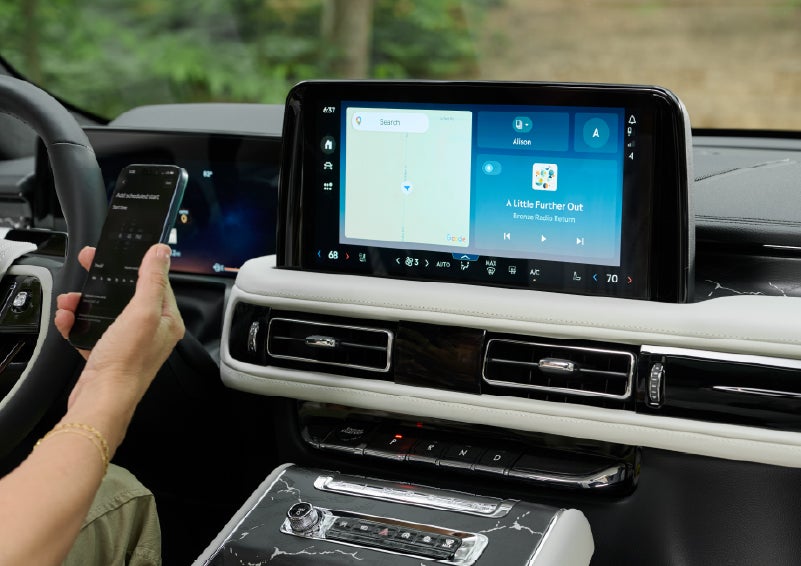 A person pairs thier phone with the center touchscreen of a 2027 Lincoln Aviator® Black Label™ SUV | Miller Lincoln in Saint Cloud MN